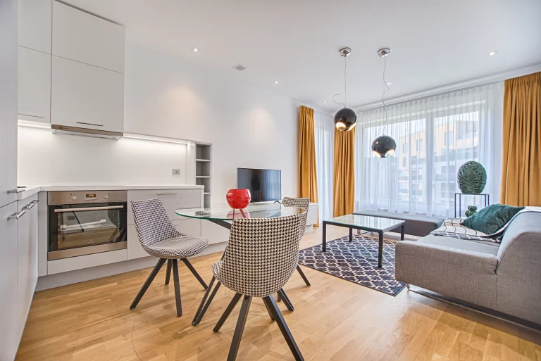 Two chairs with glass table on living room near window